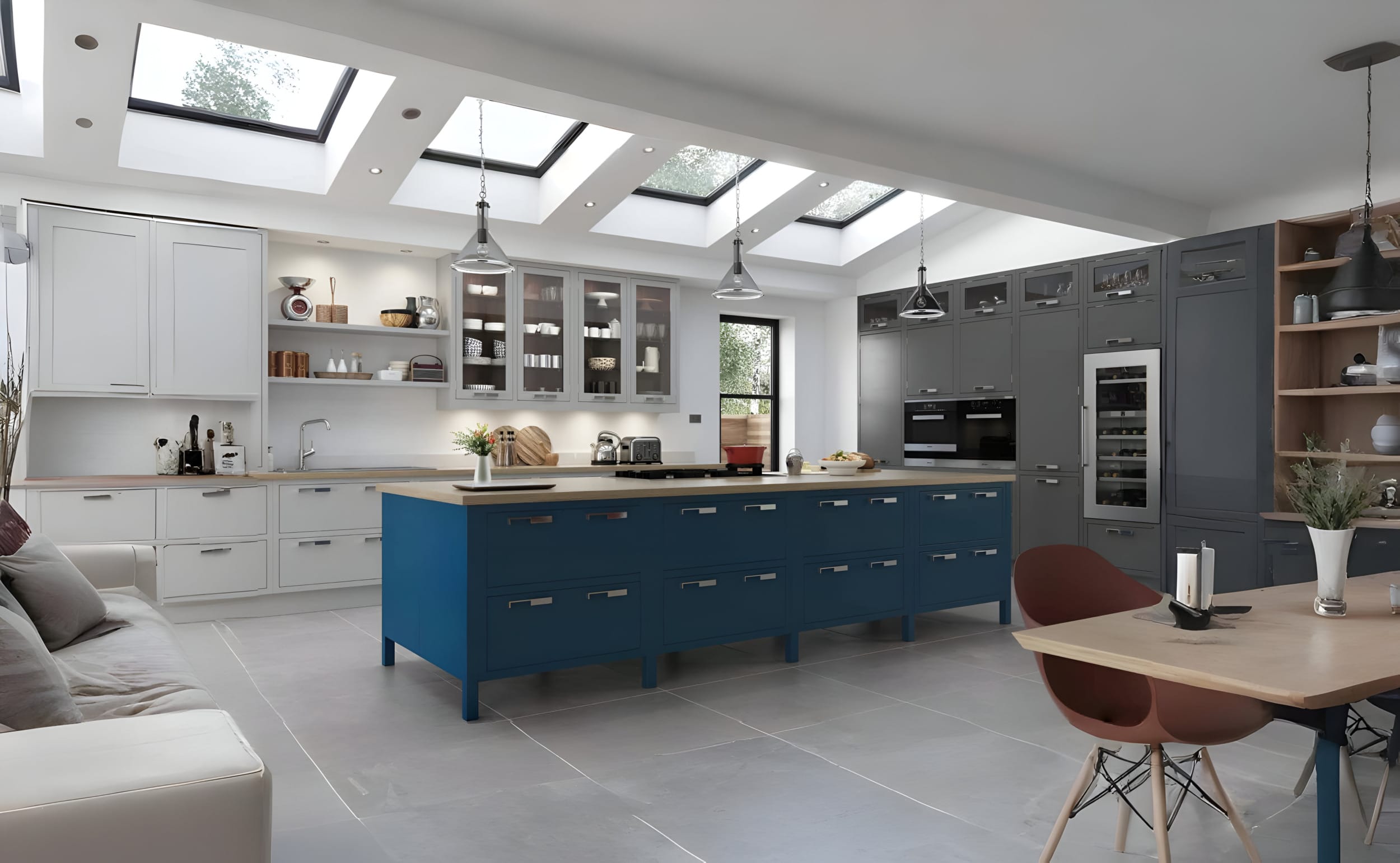 Mastercraft Aisling Bespoke in-frame kitchen with blue island, white base cabinets and tall grey larder units, featuring integrated appliances, oak shelving, and pendant lighting – a fully fitted Mastercraft kitchen with hand-built cabinetry and modern classic design.
